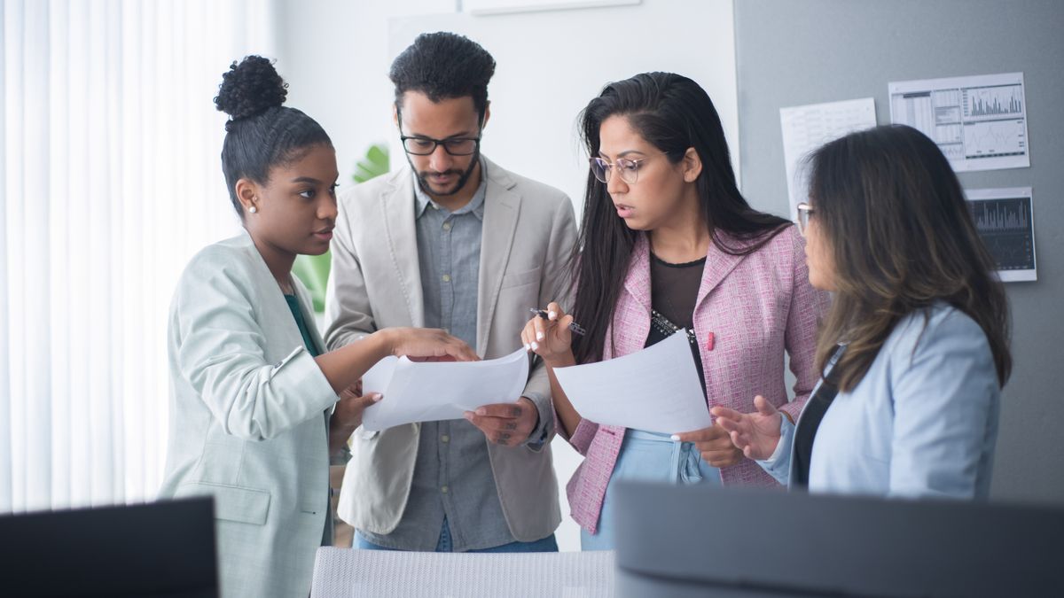 Healthcare professionals reviewing workforce data and charts together